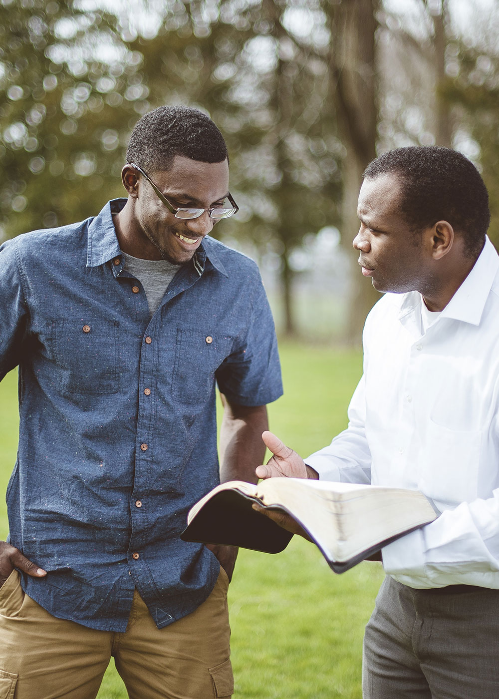 african-american-male-friends-park-discussing-bible